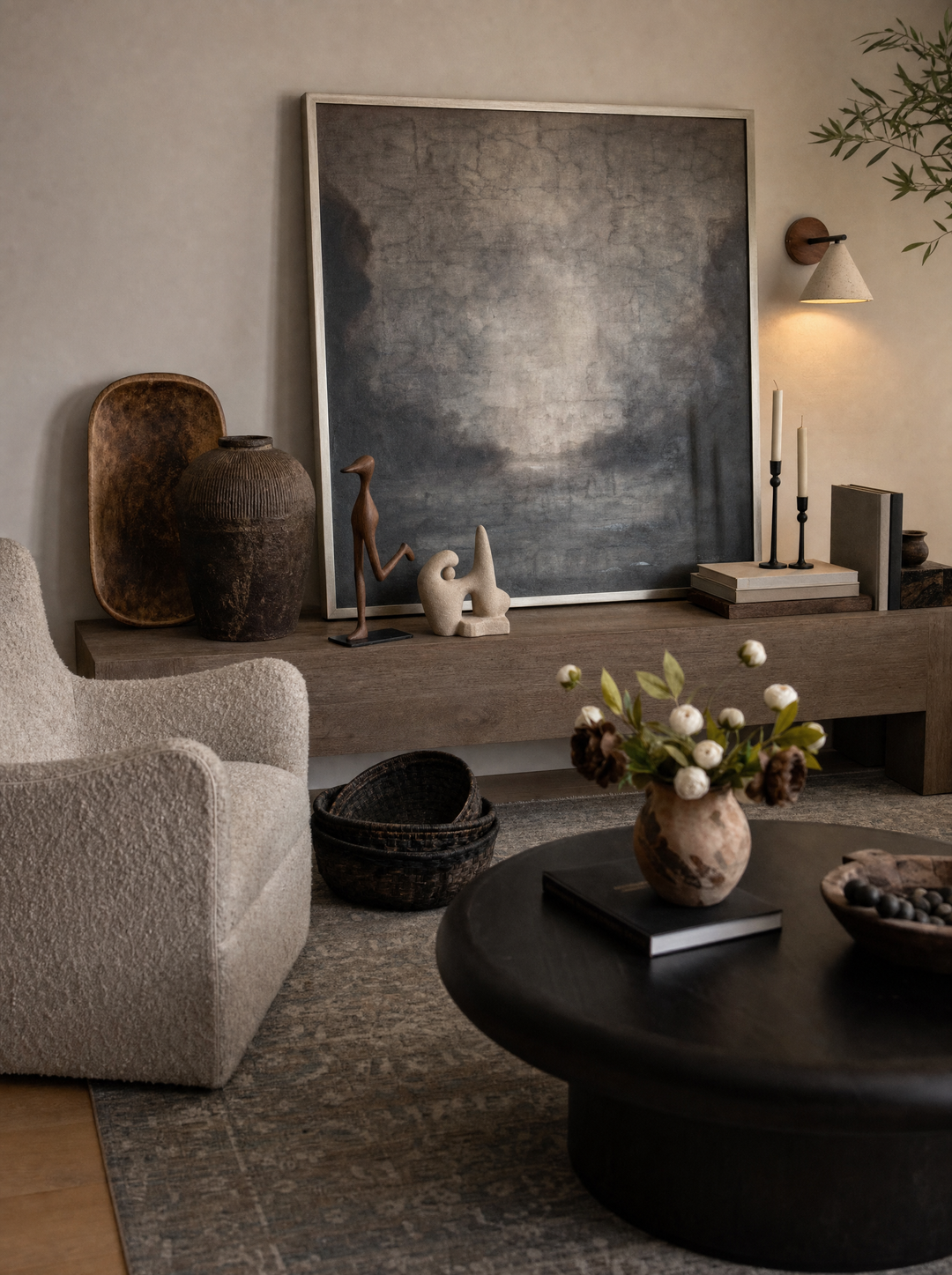 Archetypes sculpture on a console table under a Fonte wall lamp