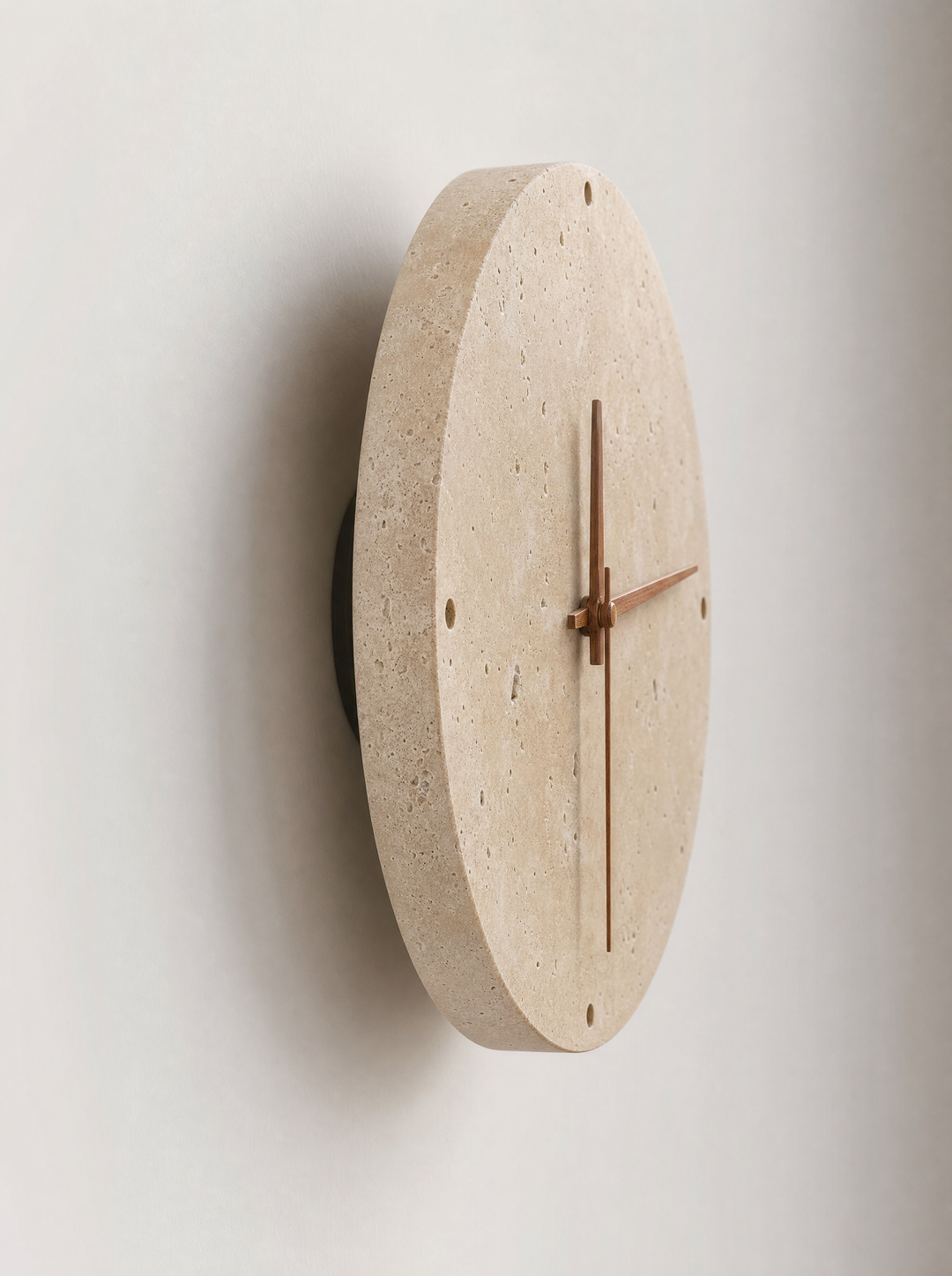 Adagio travertine wall clock at an angle, showing the disc thickness and gap from the wall
