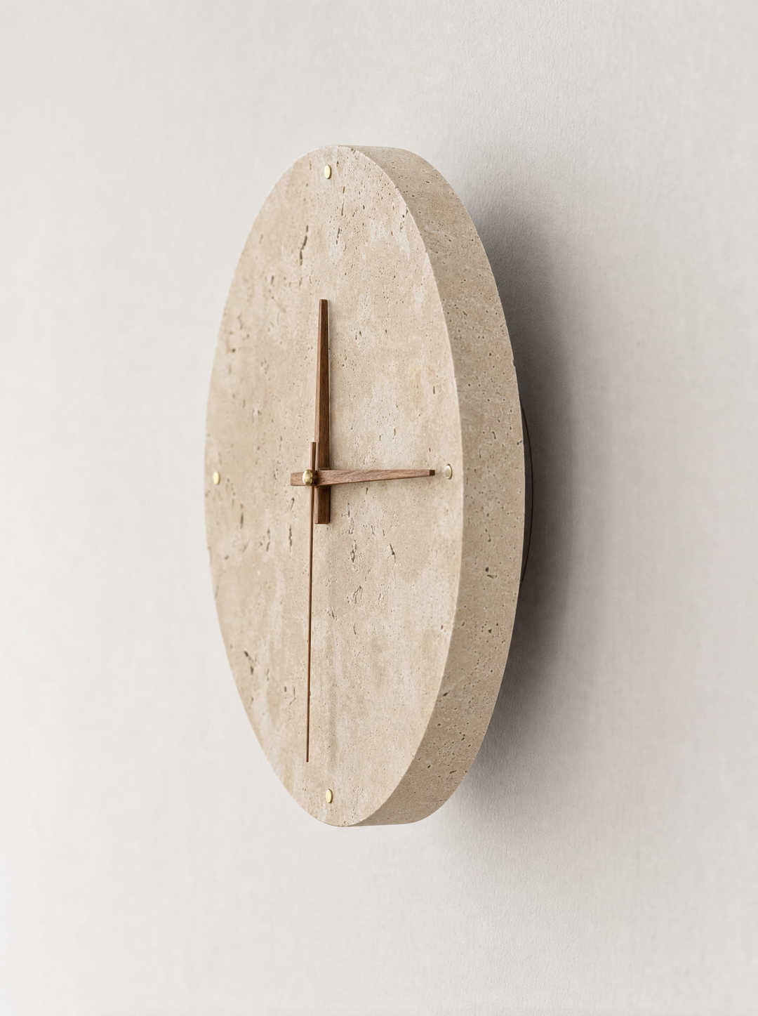 Adagio travertine wall clock at an angle, showing the disc thickness and gap from the wall