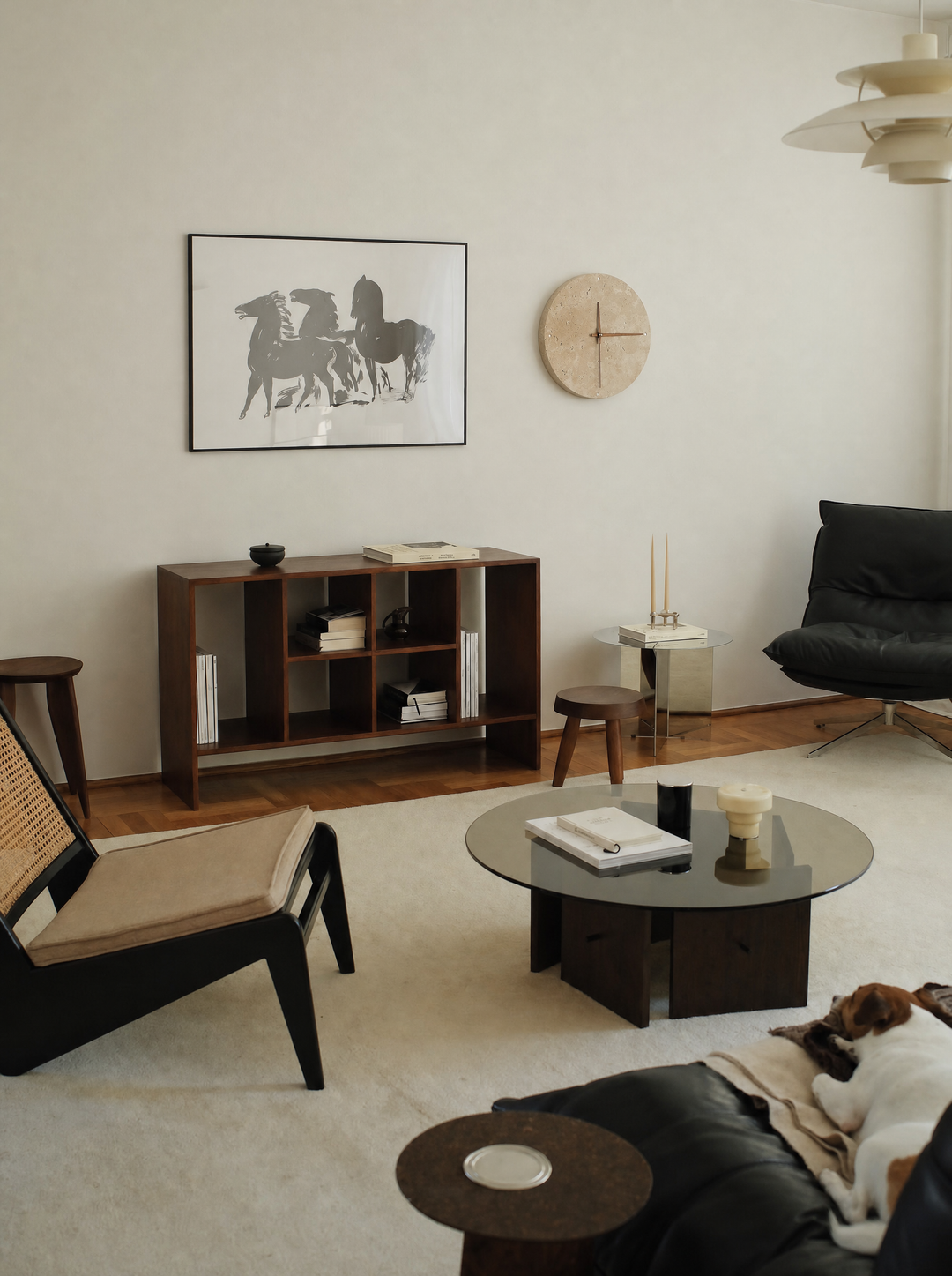 Adagio travertine wall clock, 30cm size, hanging in a living room above a console
