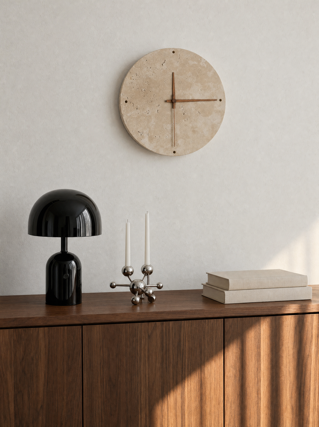Adagio wall clock on a bare wall in daylight, black Vespers lamp nearby