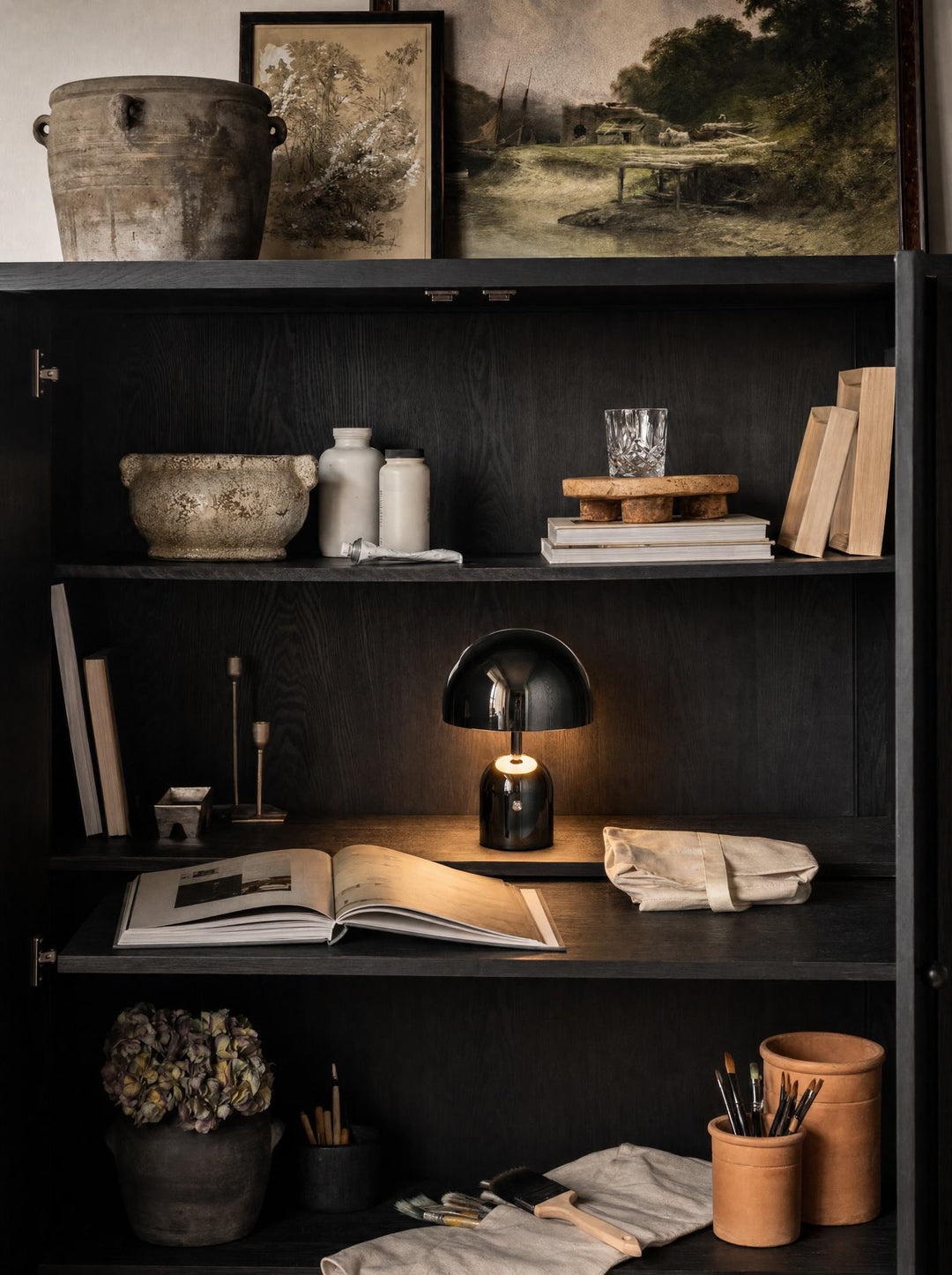 Black Vespers lamp on a black cabinet in low light