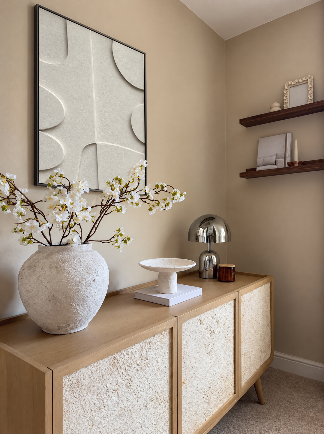 Curva Arco above an oak cabinet with a vase of blossom branches