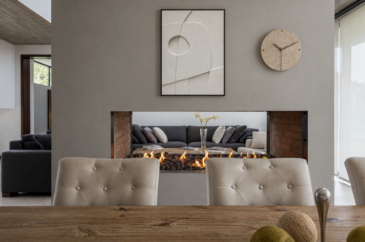 Curva Orma above a see-through fireplace in a dining room