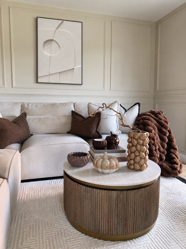 Curva Orma inside a molded wall panel above a cream sofa