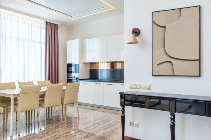 Curva Sasso above a black console table in an open kitchen and dining room