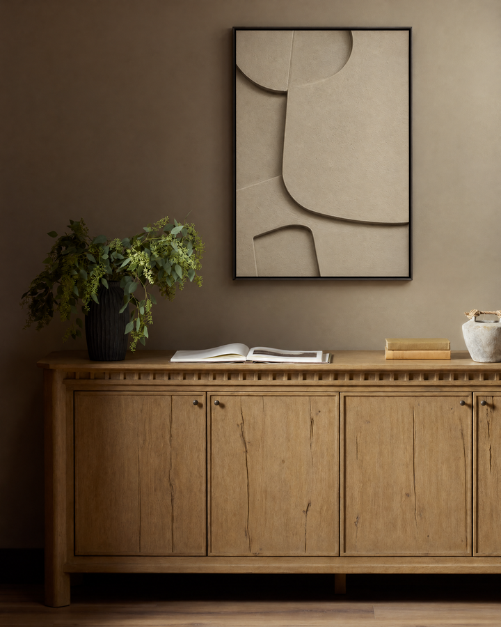 Curva Sasso above a long oak sideboard on a warm brown wall