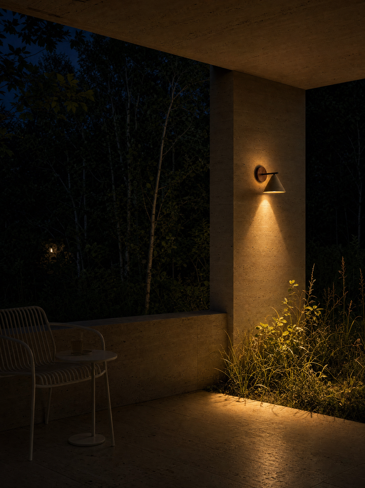 Fonte wall lamp at night on a travertine porch, warm light on foliage