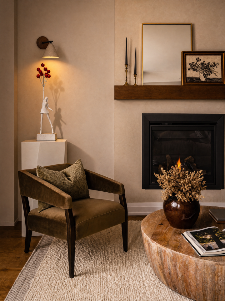 Fonte wall lamp lighting the Elevate sculpture on a plinth beside a fireplace