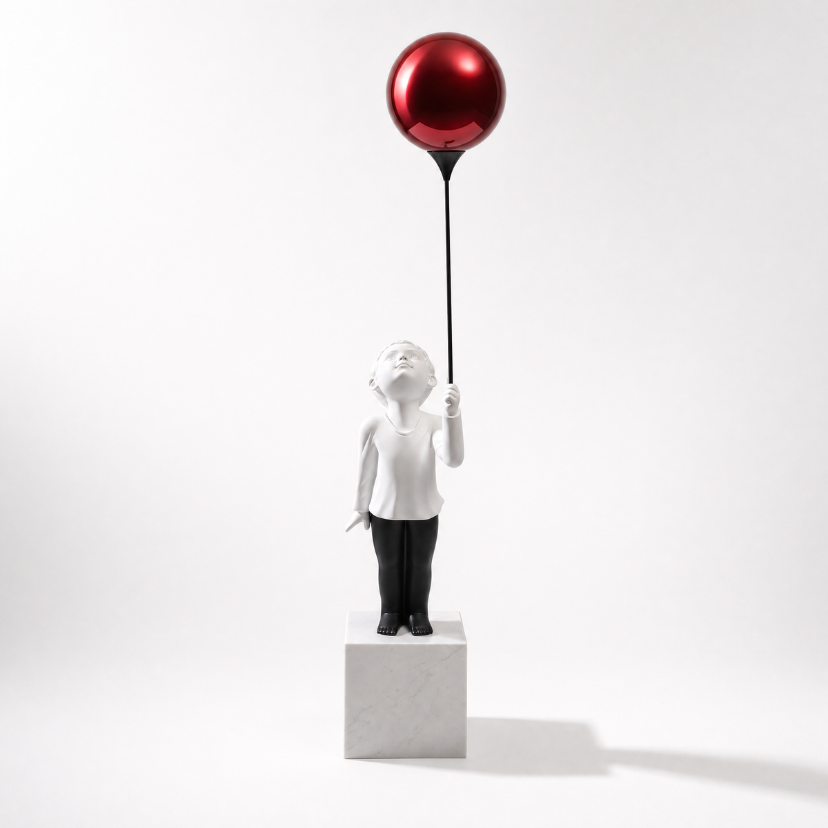 The original AeroCherub, red balloon, white marble cube, plain white background