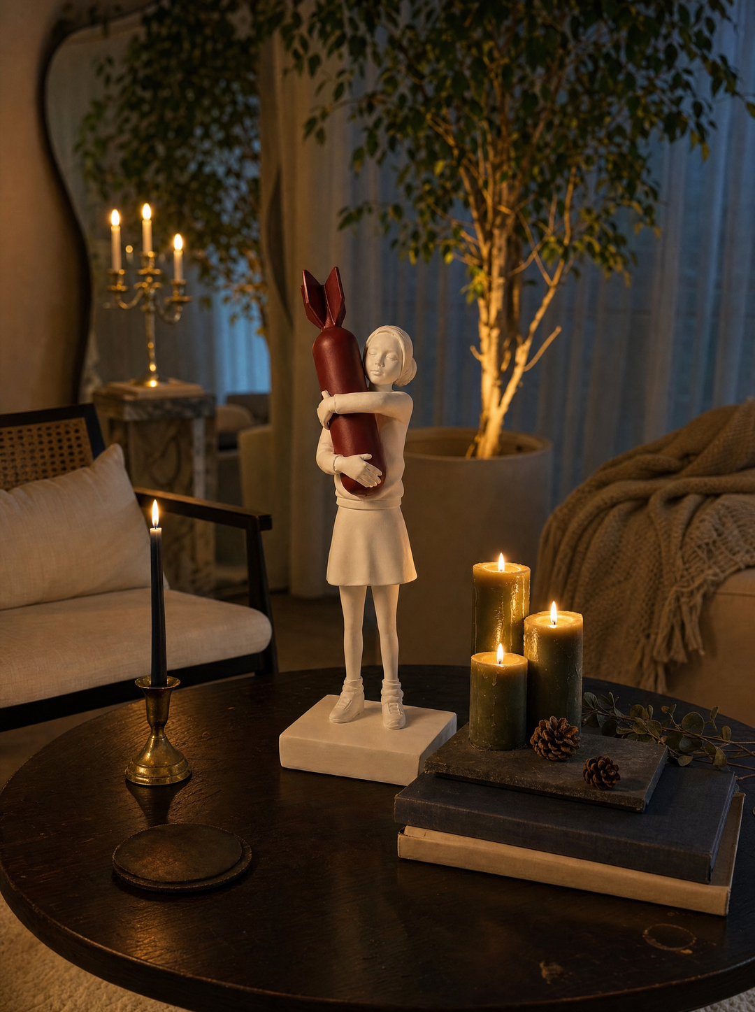 Disarm sculpture on a round table among lit candles and pine cones at night