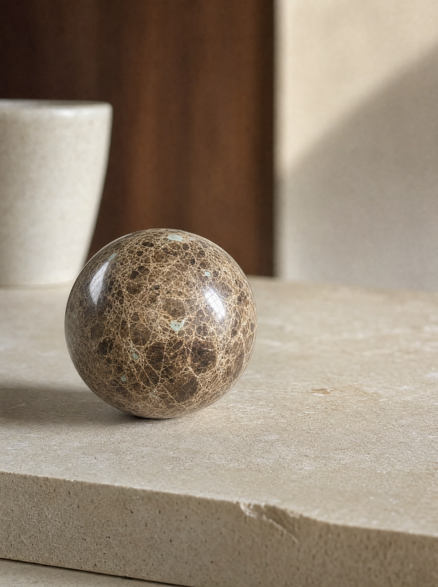 Macro detail of a single dark marble sphere, veining visible.