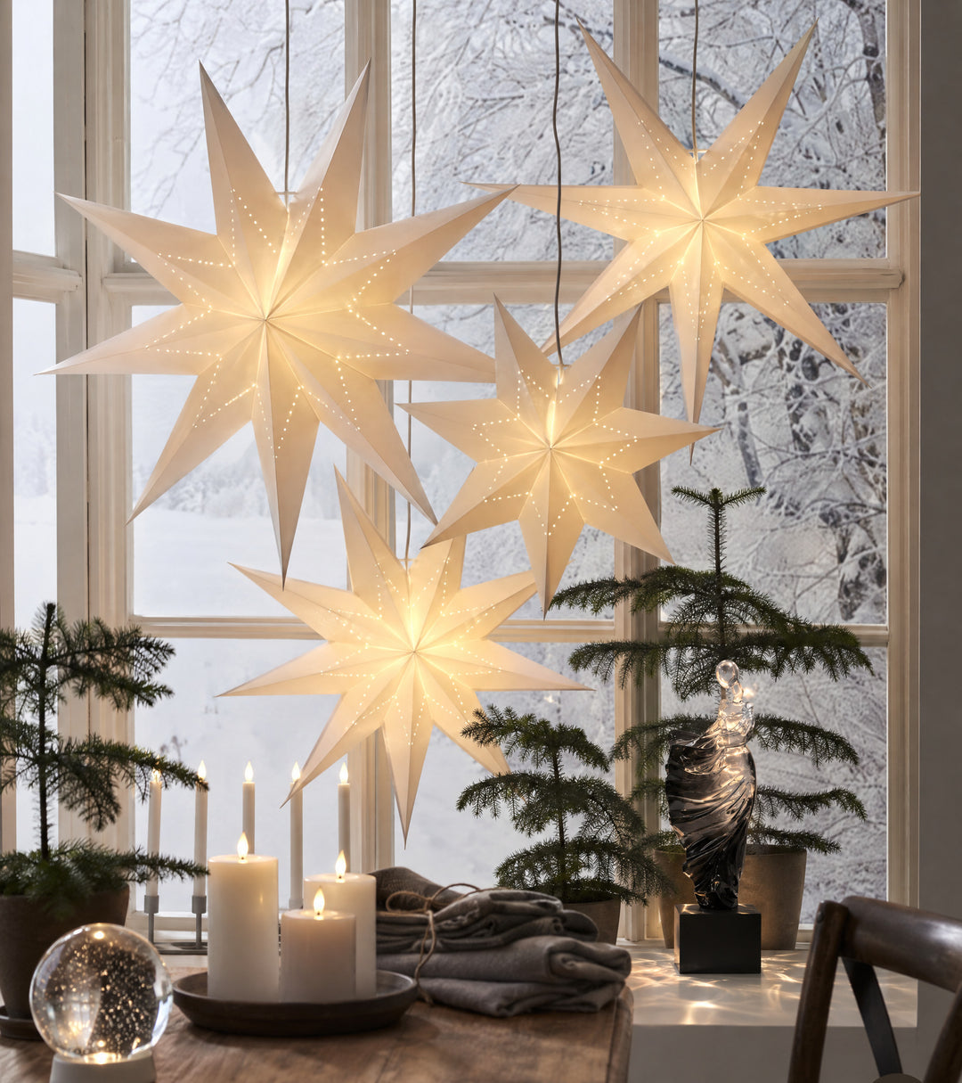 Dualité, a translucent figure, stands against a bright snowy window, light at the crown and dark at the base.