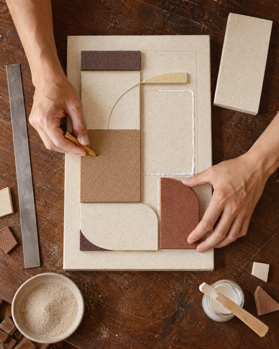 An artisan shaping the raised squares of Rilievo by hand