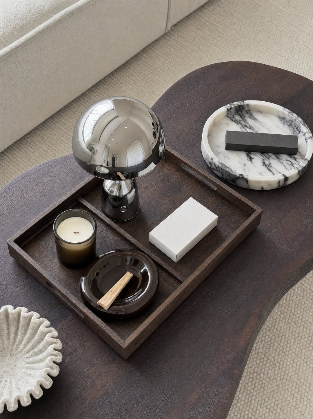 Silver Vespers lamp on a wooden tray with a candle and a marble dish
