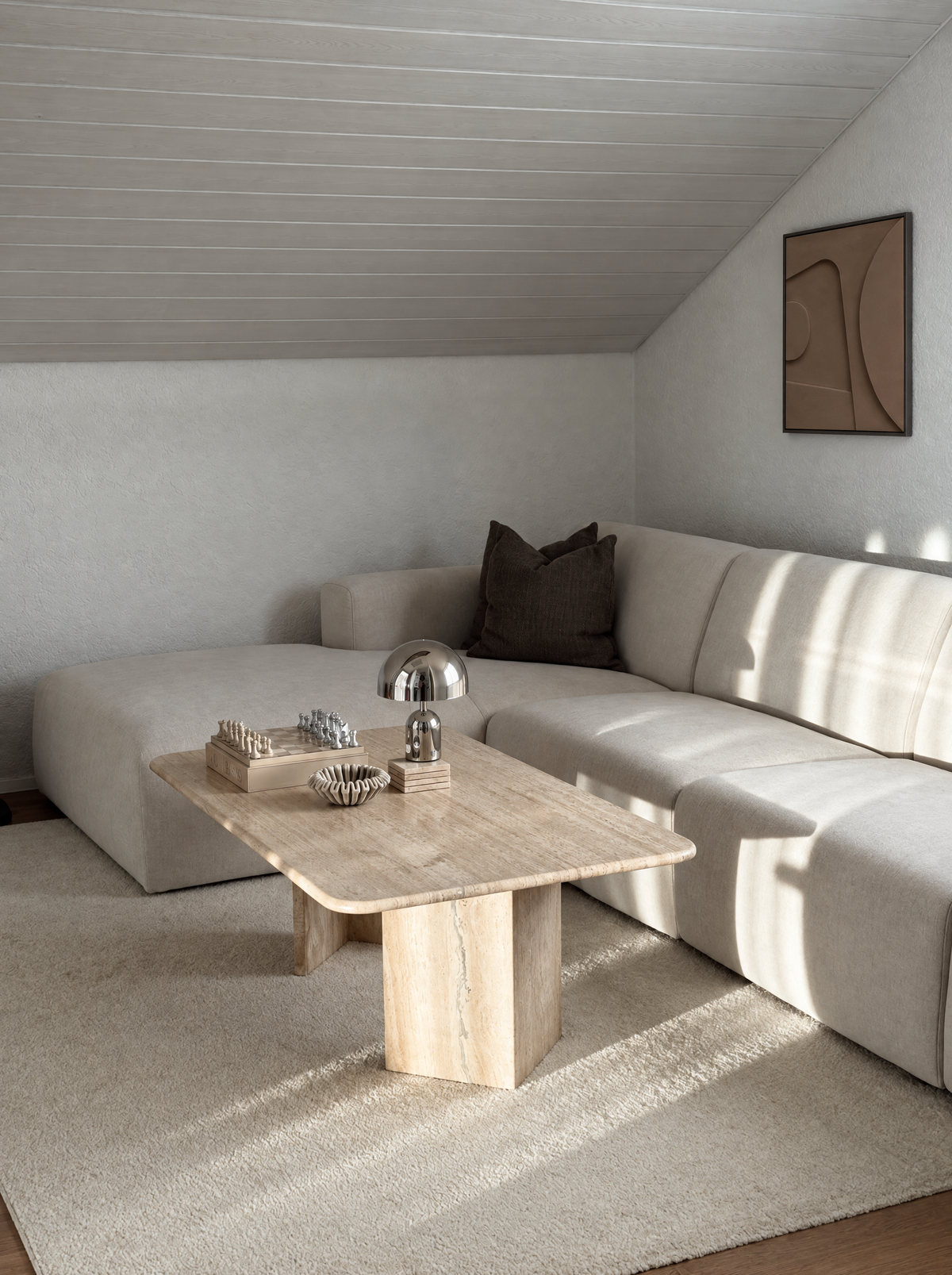 Tinta in Argilla hung on a white wall above a cream corner sofa in an attic room