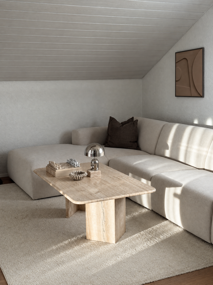 Tinta in Argilla hung on a white wall above a cream corner sofa in an attic room