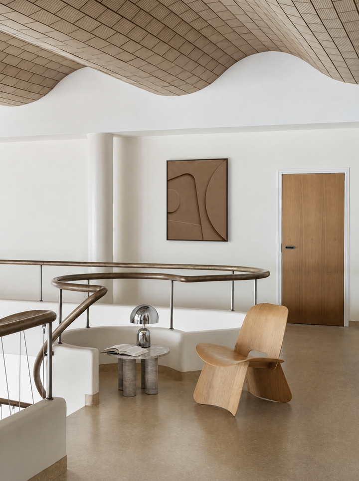 Tinta in Argilla hung on a white mezzanine wall beside a door, above a curved railing
