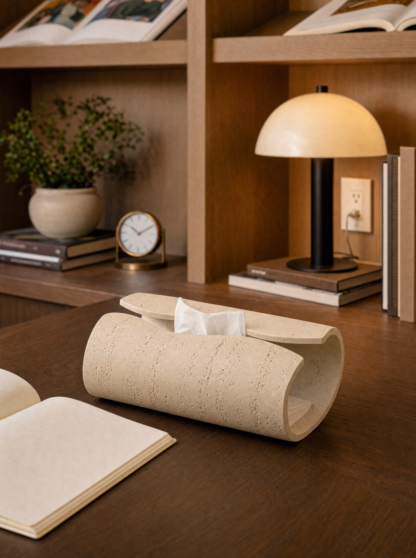 Volute ceramic tissue holder styled on a desk corner.