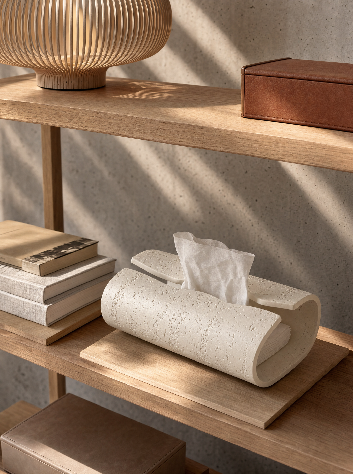 Volute ceramic surface close-up, matte pitted texture that recalls travertine.